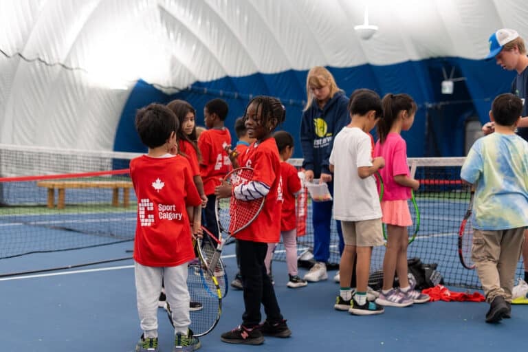 Kids get ready to take part in a tennis game