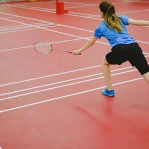 female badminton player hits birdie