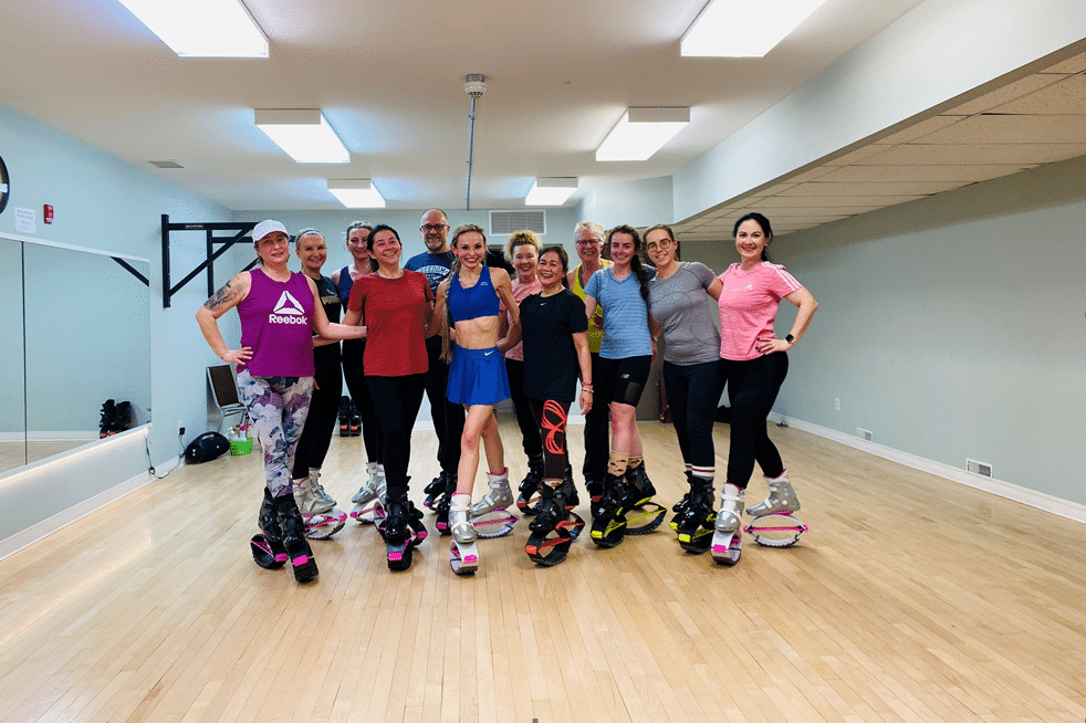 A group of ladies wear jumpfit shoes and pose in group photo