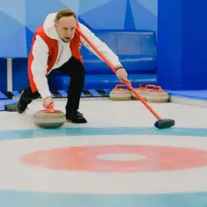 Curling sport player gets ready
